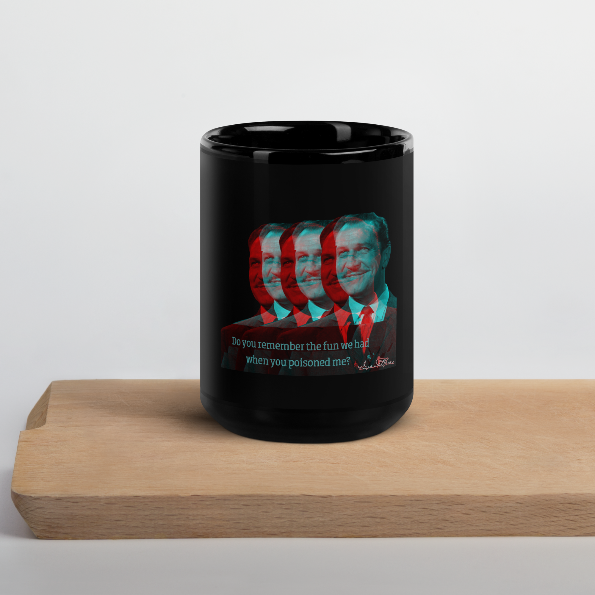 A black ceramic mug with a psychedelic design featuring the likeness of Vincent Price, placed on a wooden board.