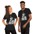 A man and a woman smiling, wearing a black t-shirt with a grayscale illustration of a person in the center.