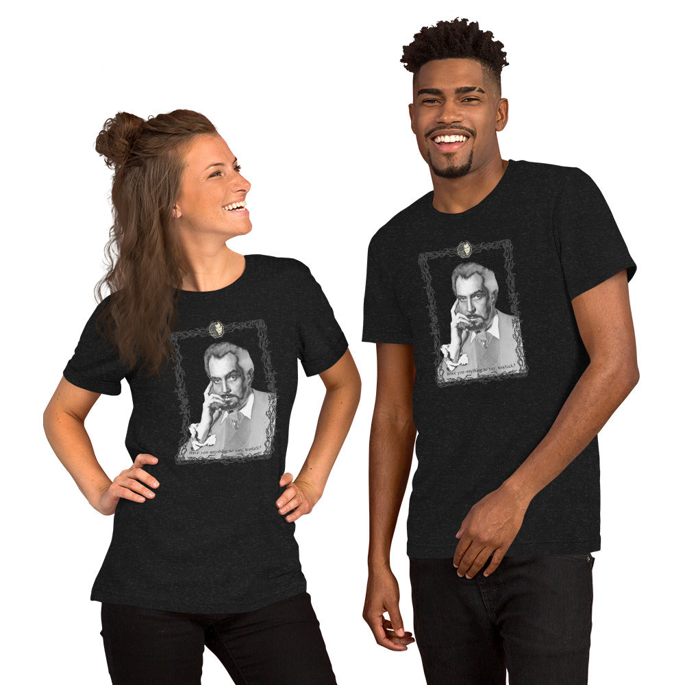 Two models wearing matching dark heather gray unisex t-shirts featuring a vintage black-and-white portrait illustration of a man in a decorative ornate frame with small text beneath it. The woman on the left has her hair up and is laughing; the man on the right is smiling broadly. Both shirts appear to be the same design on a white background.
